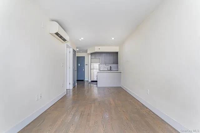 a view of a kitchen with a sink and a refrigerator