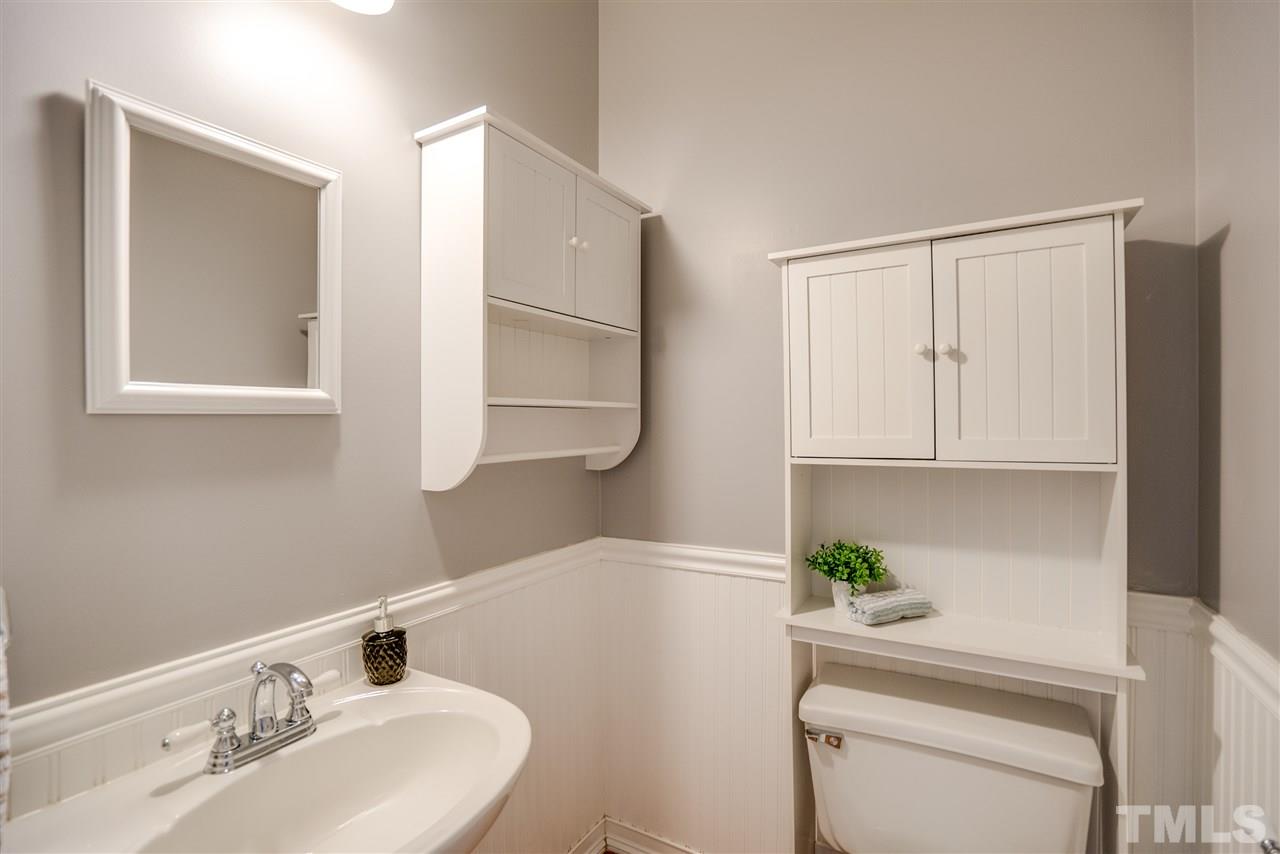 9905 Rimwood Court Raleigh, NC 27613 - Photo 14 of 24 a bathroom with a sink a toilet and vanity