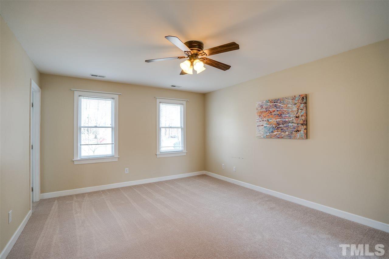 9905 Rimwood Court Raleigh, NC 27613 - Photo 15 of 24 a view of a livingroom with a ceiling fan and window
