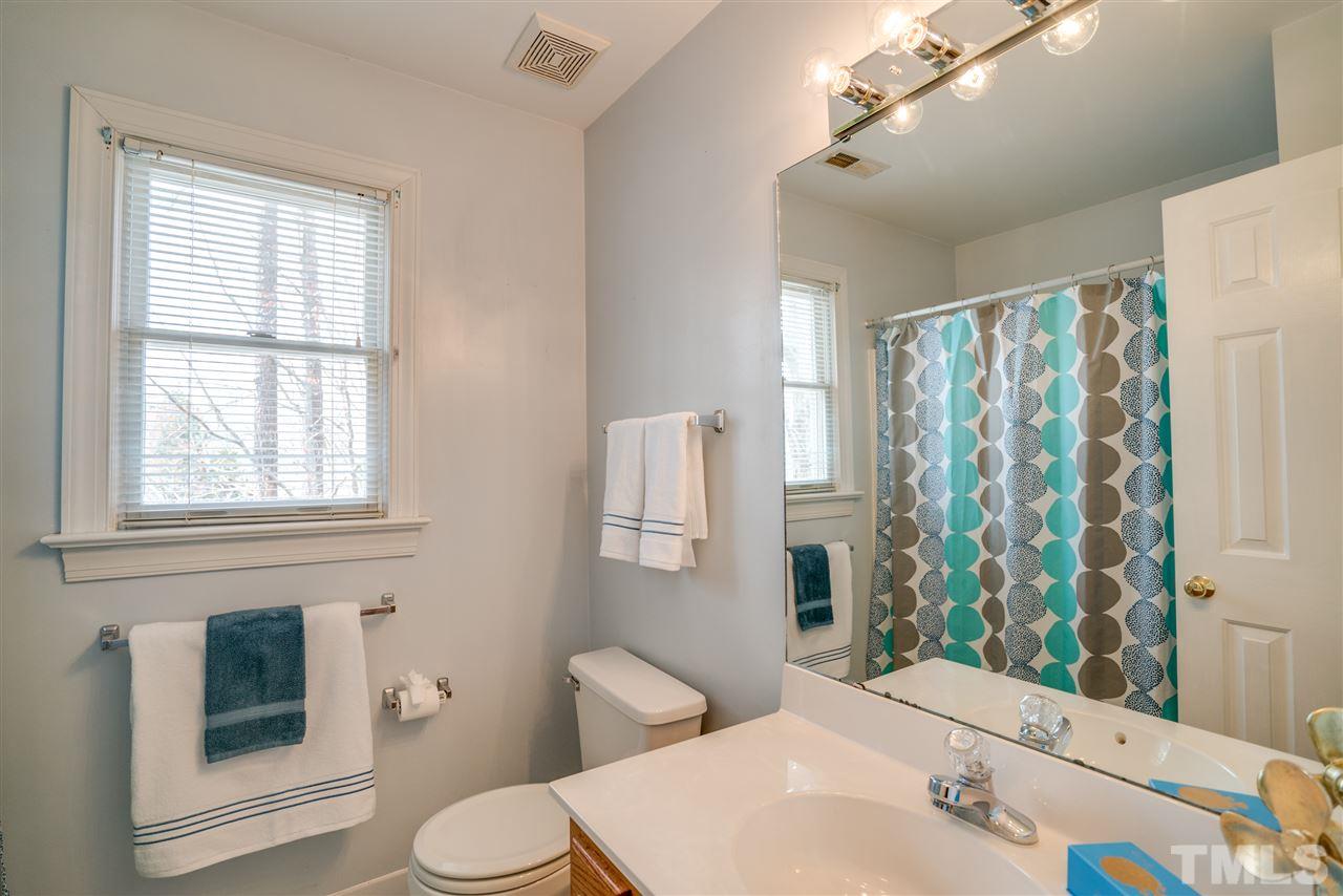 9905 Rimwood Court Raleigh, NC 27613 - Photo 20 of 24 a bathroom with a sink toilet and shower