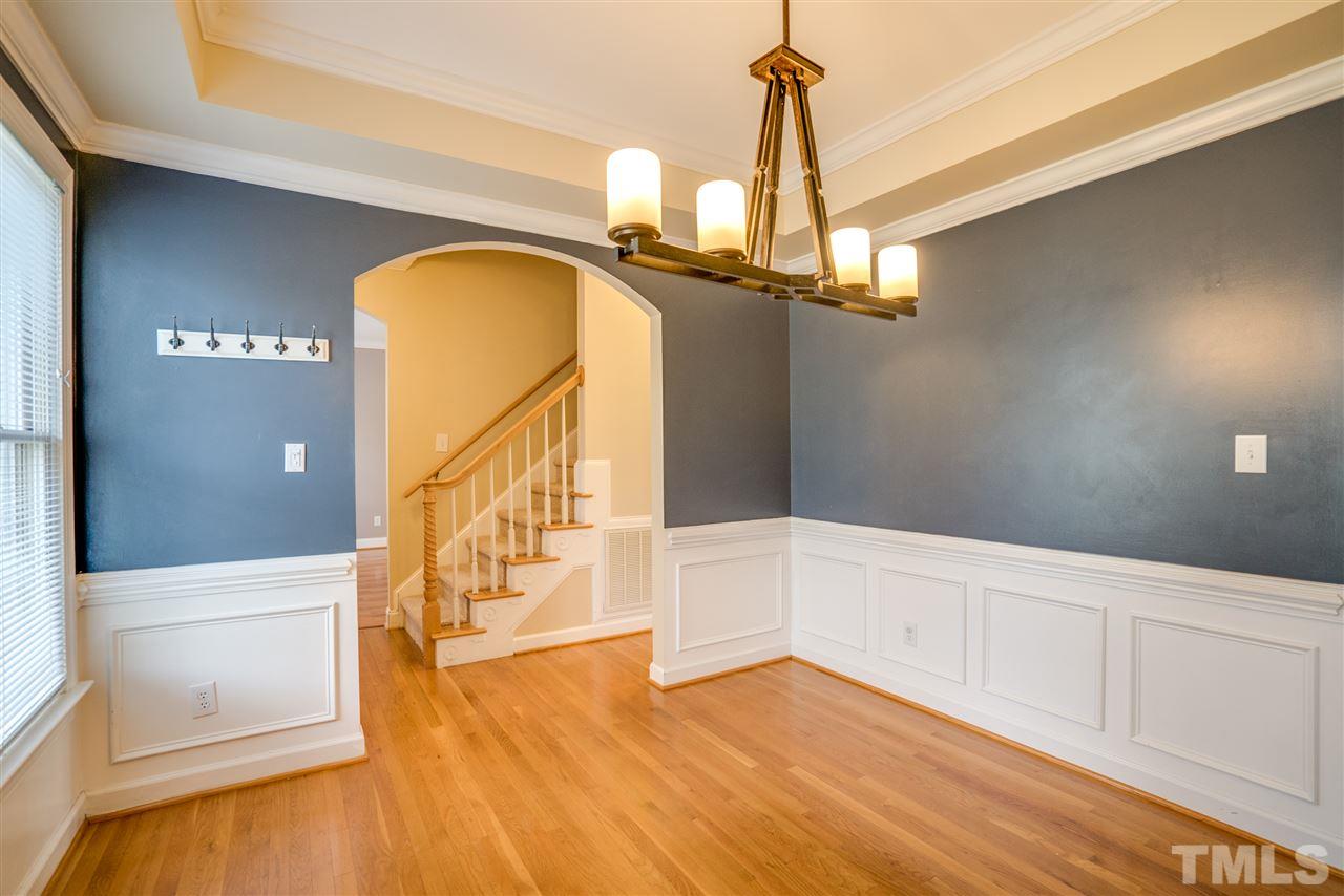 9905 Rimwood Court Raleigh, NC 27613 - Photo 4 of 24 a view of a room with wooden floor and staircase