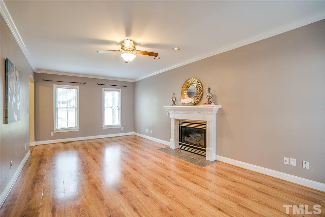 9905 Rimwood Court Raleigh, NC 27613 - Photo 5 of 24 a view of empty room with wooden floor and fan