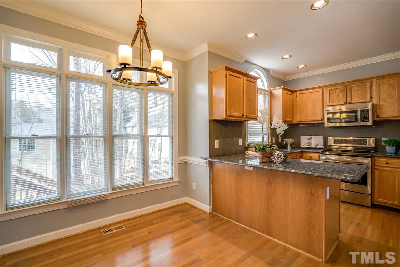 9905 Rimwood Court Raleigh, NC 27613 - Photo 8 of 24 a kitchen with stainless steel appliances granite countertop a sink stove and refrigerator