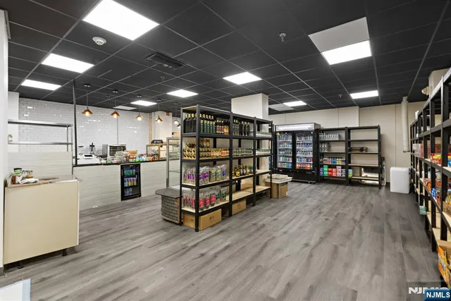 a living room with furniture a dining table and a chandelier