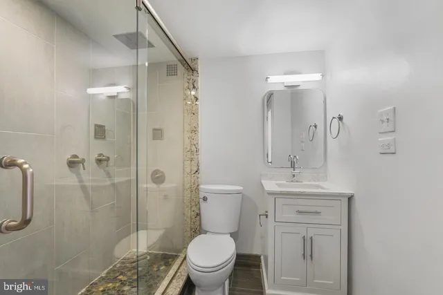 a bathroom with a toilet a sink and shower