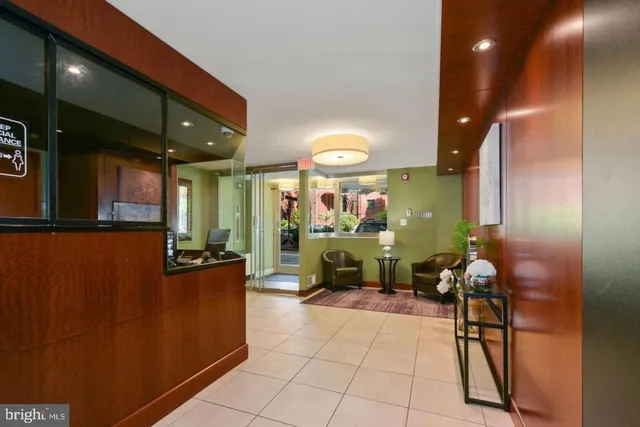 a lobby with furniture and a potted plant