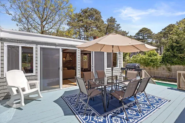 a view of a patio with furniture and a garden