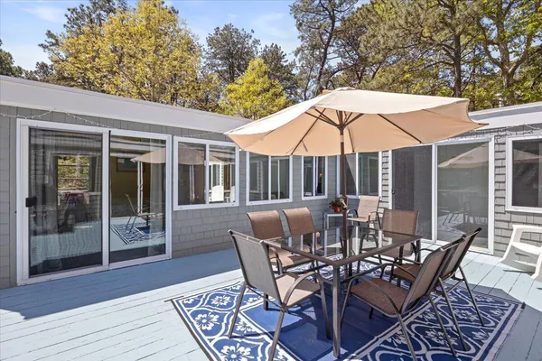 a view of a patio with table and chairs under an umbrella