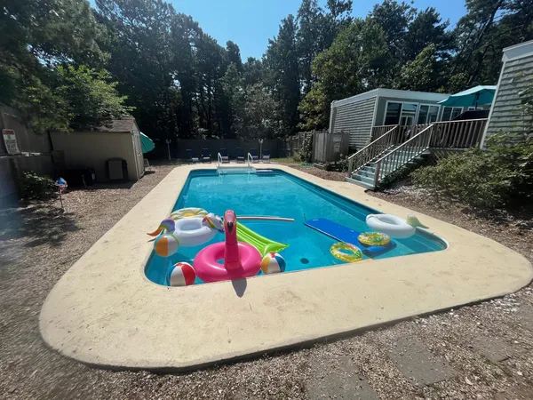 a view of a swimming pool with a yard