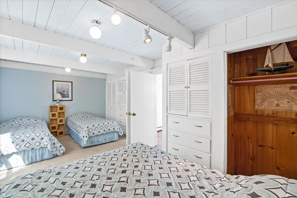 a bedroom with a bed and walk in closet