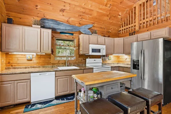 a kitchen with stainless steel appliances a stove a sink dishwasher and a refrigerator