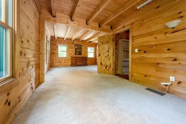 a view of an empty room with a fireplace