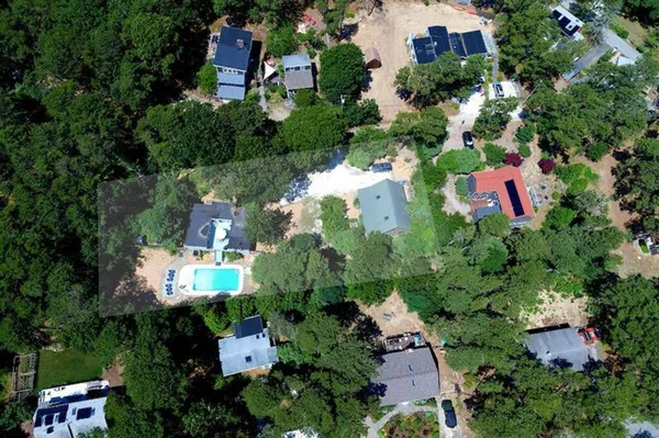 an aerial view of residential house with outdoor space and swimming pool