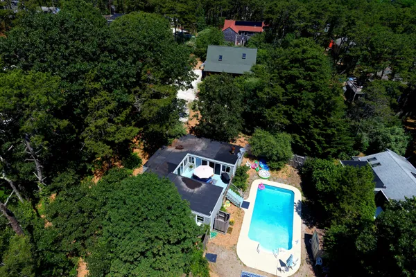 an aerial view of a house with a yard