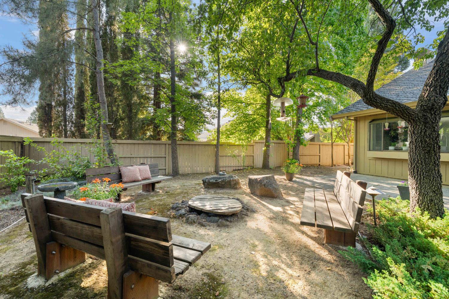 a view of a patio with couches table and chairs and potted plants