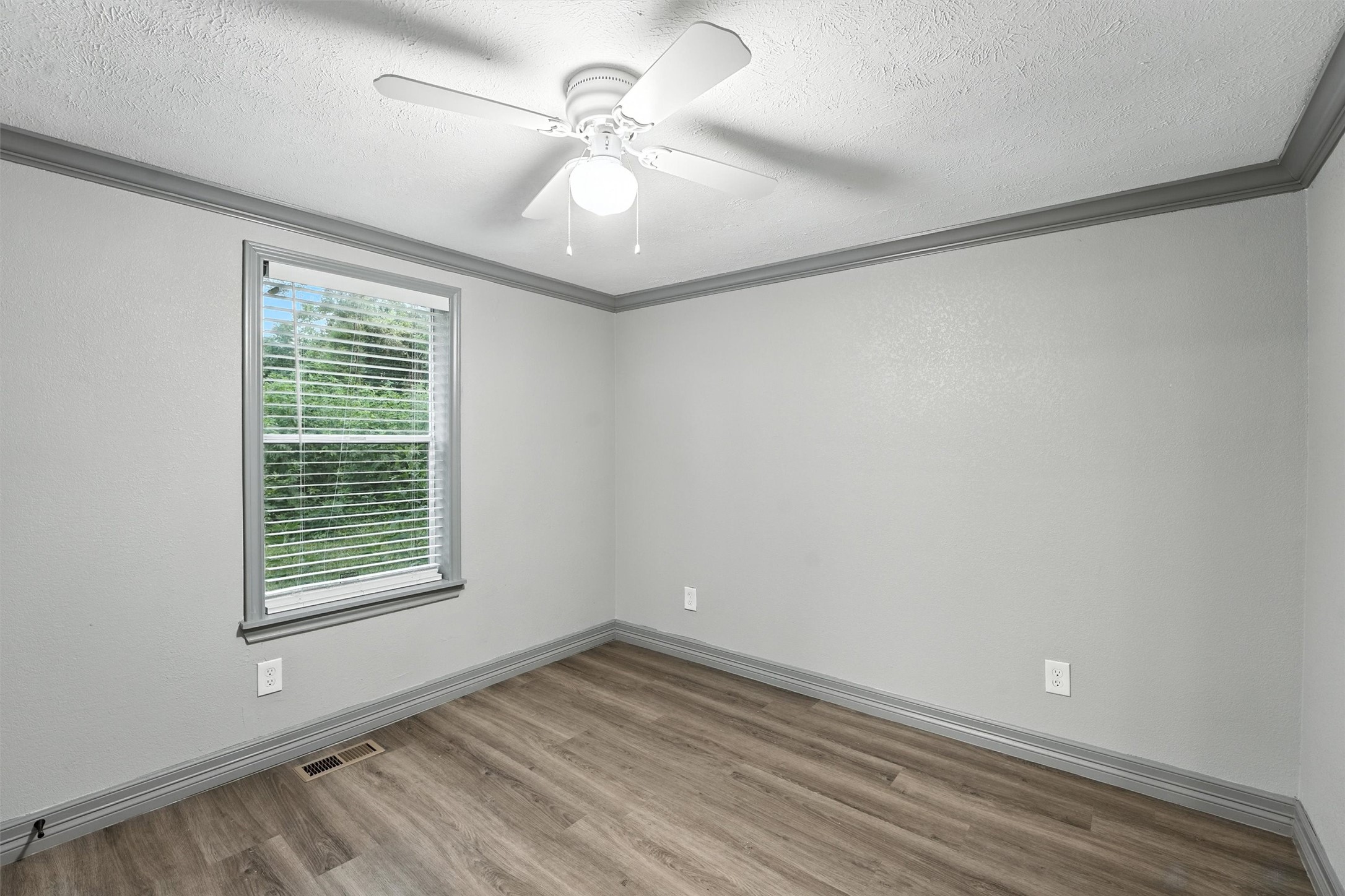 110 Robin Street Shepherd, TX 77371 - Photo 12 of 23 wooden floor in an empty room with a window
