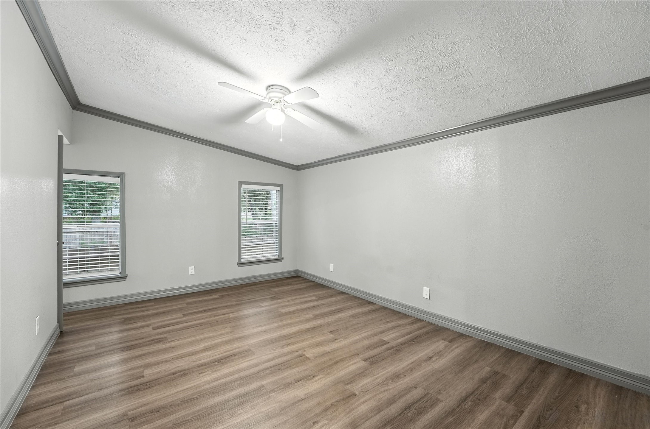 110 Robin Street Shepherd, TX 77371 - Photo 13 of 23 a view of an empty room with a window and wooden floor