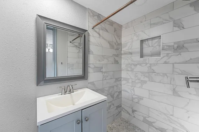 a bathroom with a sink and a mirror