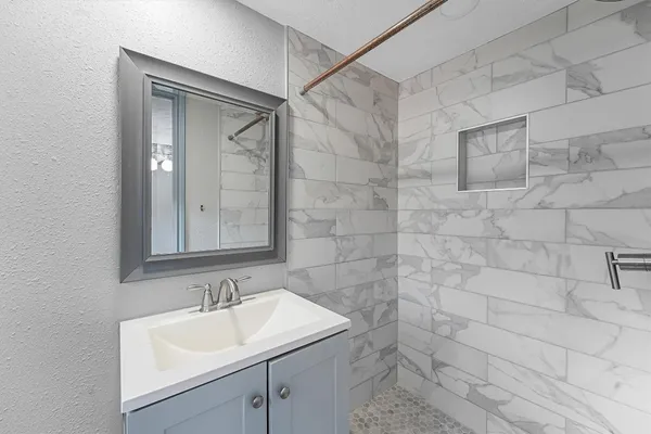 a bathroom with a sink and a mirror