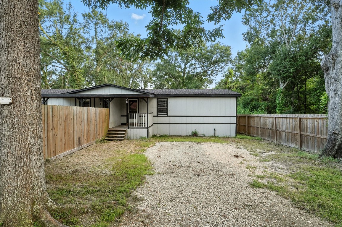 110 Robin Street Shepherd, TX 77371 - Photo 18 of 23 a backyard of a house with wooden fence