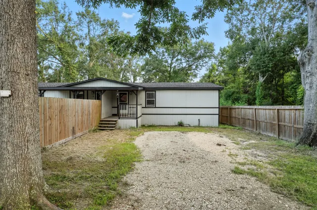 a backyard of a house with wooden fence