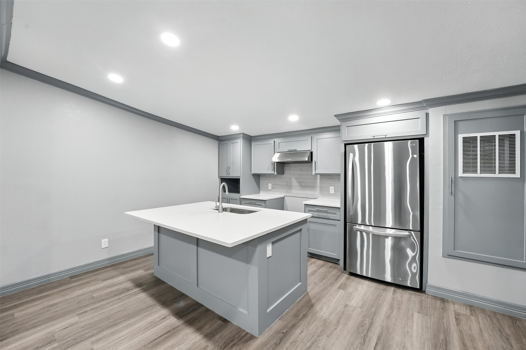 110 Robin Street Shepherd, TX 77371 - Photo 19 of 23 a kitchen with a refrigerator a sink and wooden floor