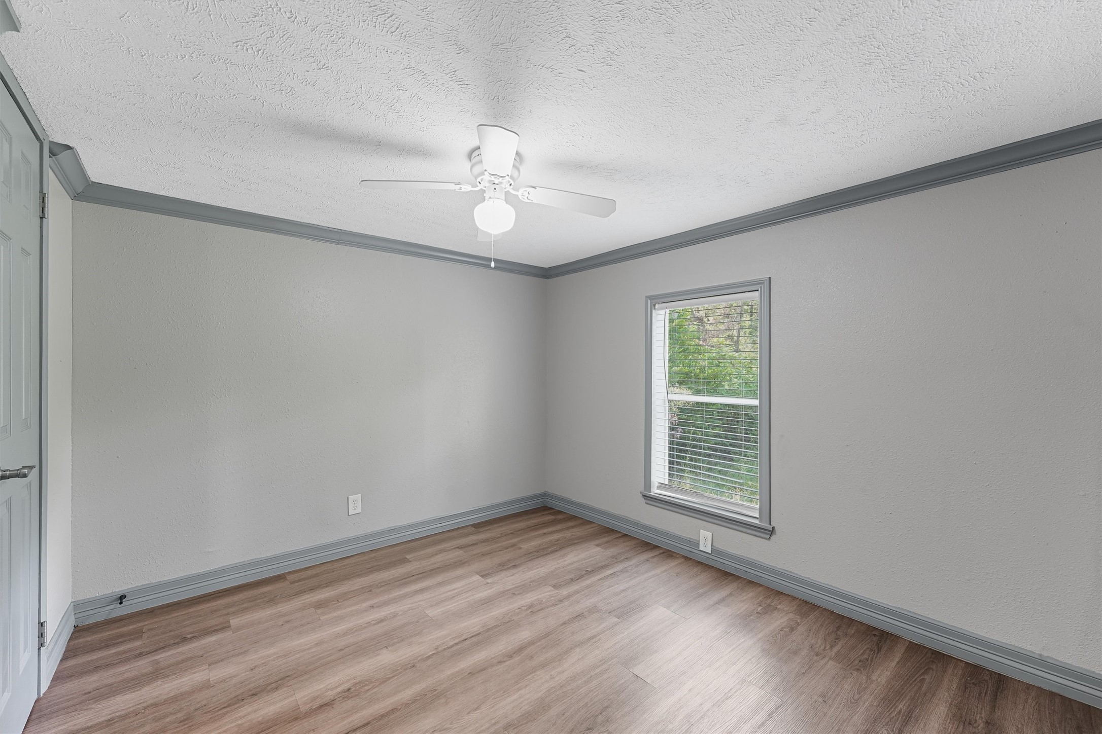 110 Robin Street Shepherd, TX 77371 - Photo 2 of 23 wooden floor in an empty room with a window