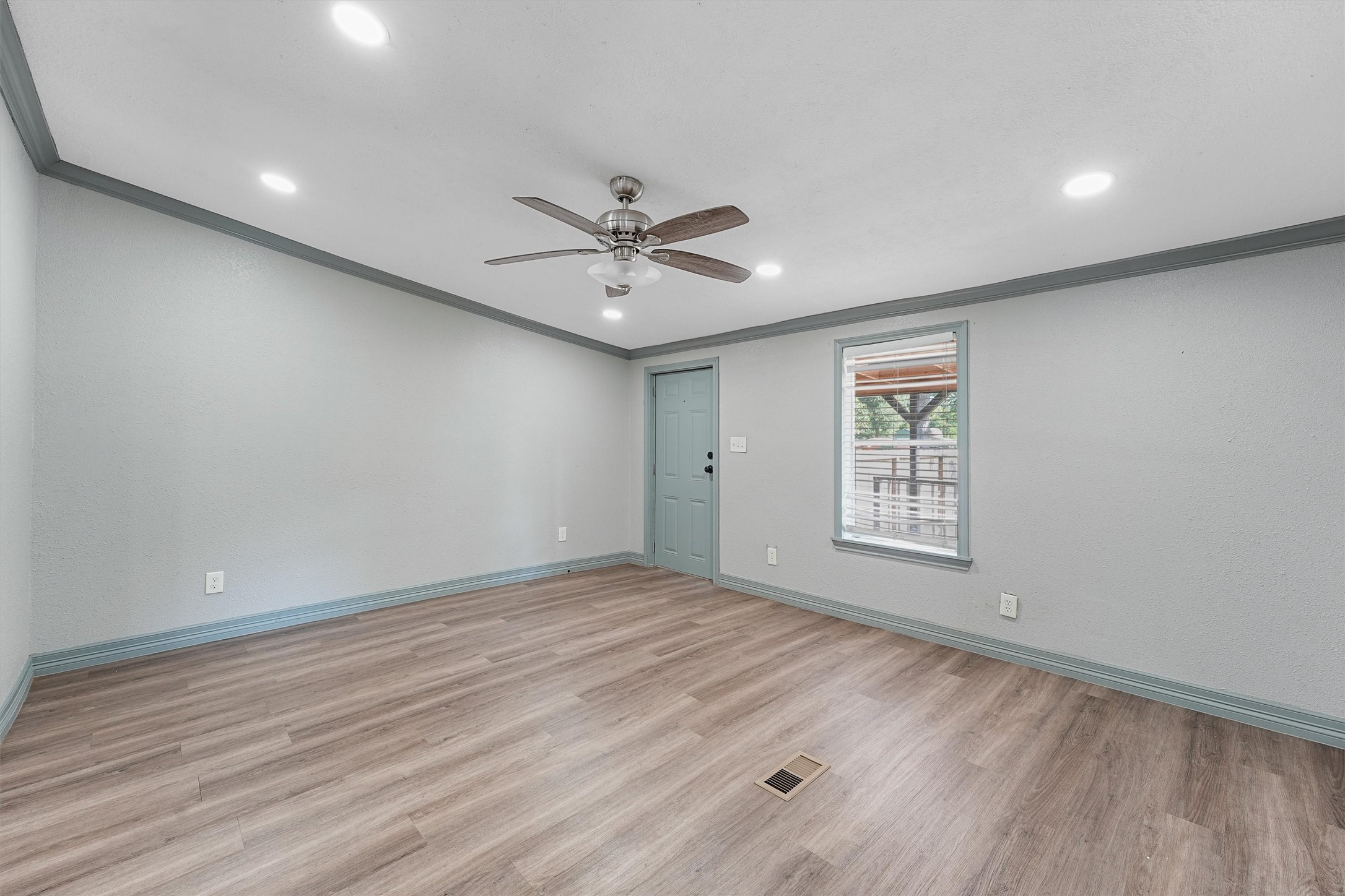 110 Robin Street Shepherd, TX 77371 - Photo 3 of 23 wooden floor in an empty room with a window