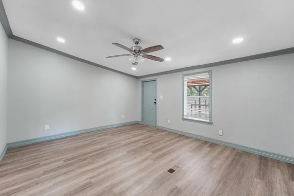 wooden floor in an empty room with a window