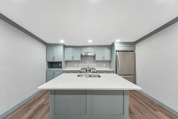 a kitchen with a sink cabinets and stainless steel appliances
