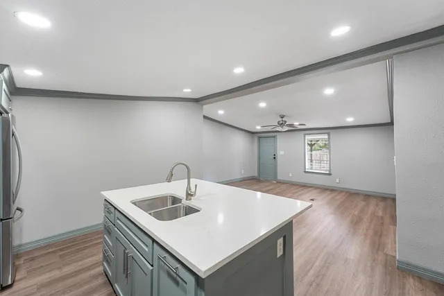 a kitchen with a sink and a refrigerator