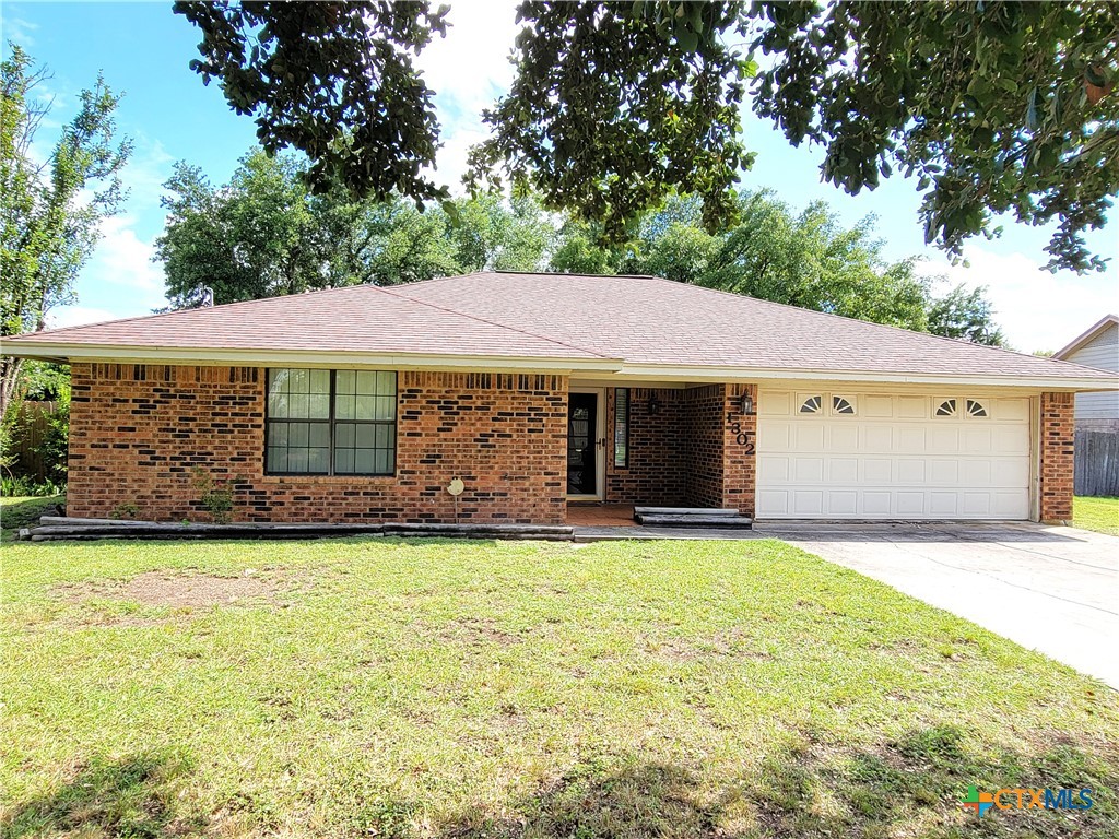 1302 Ginger Road Killeen, TX 76549 - Photo 1 of 1 a front view of a house with a yard and garage