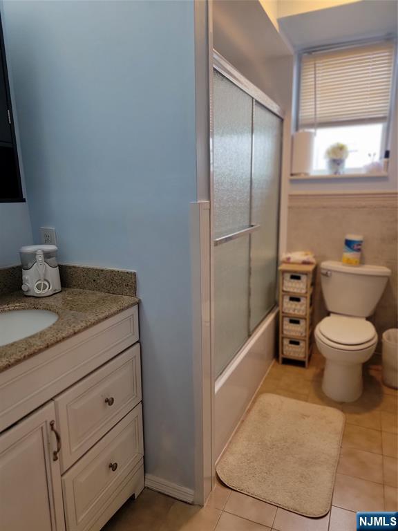 63-69 Rome Street Newark, NJ 07105 - Photo 11 of 11 a bathroom with a granite countertop toilet and a sink