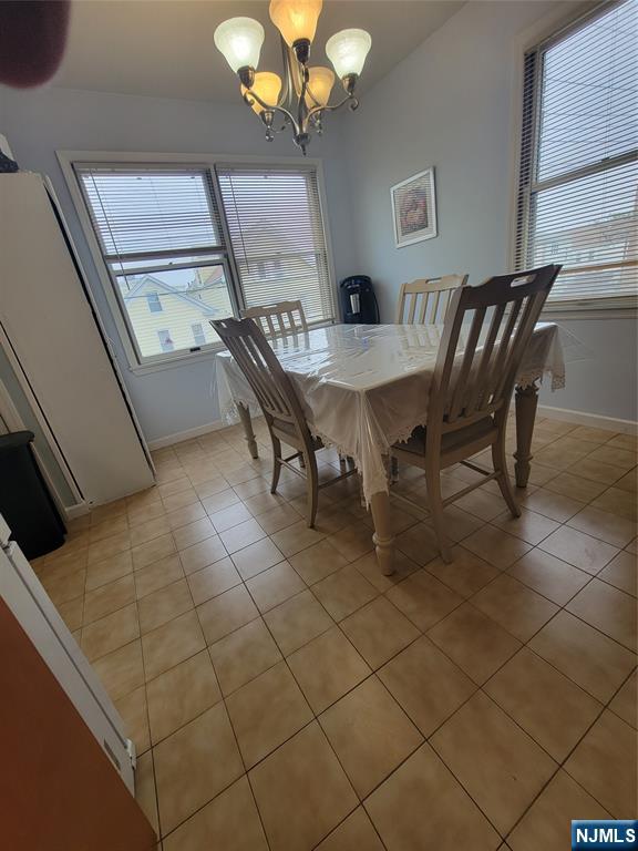 63-69 Rome Street Newark, NJ 07105 - Photo 5 of 11 a dining room with furniture and a chandelier