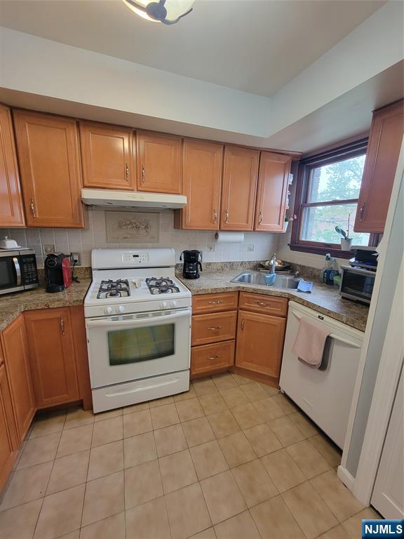 63-69 Rome Street Newark, NJ 07105 - Photo 6 of 11 a kitchen with a stove sink and cabinets