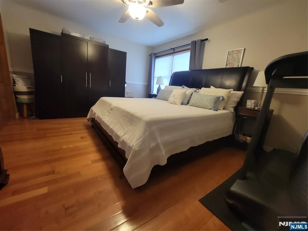 63-69 Rome Street Newark, NJ 07105 - Photo 8 of 11 a spacious bedroom with a bed and a chandelier