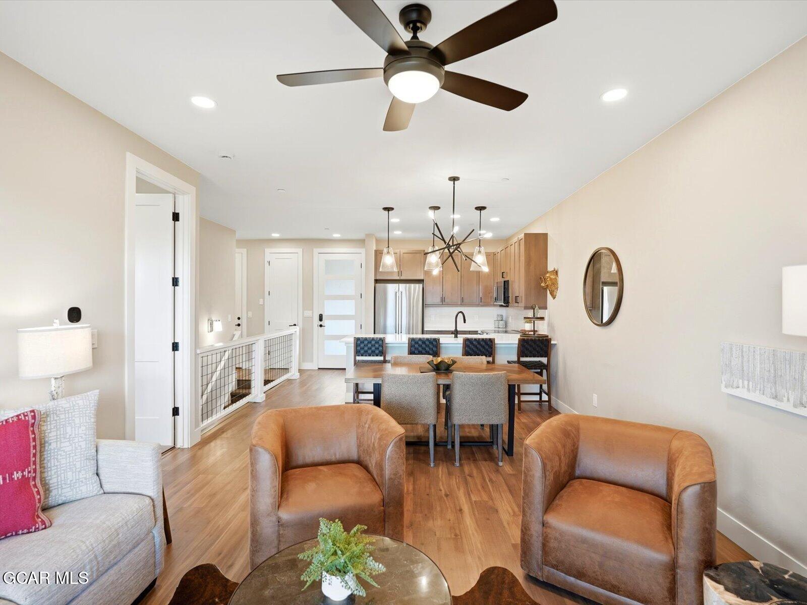 95 River Run Circle Fraser, CO 80442 - Photo 25 of 66 a living room with lots of furniture and a chandelier
