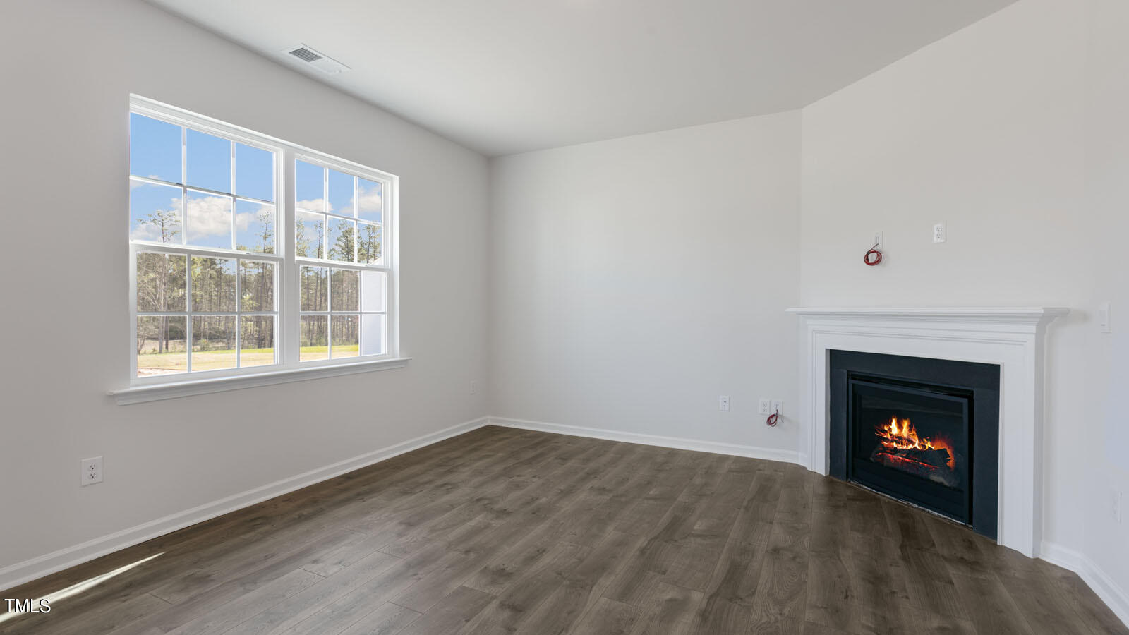 361 Ashley Run Sanford, NC 27330 - Photo 9 of 46 a view of an empty room with wooden floor and a window