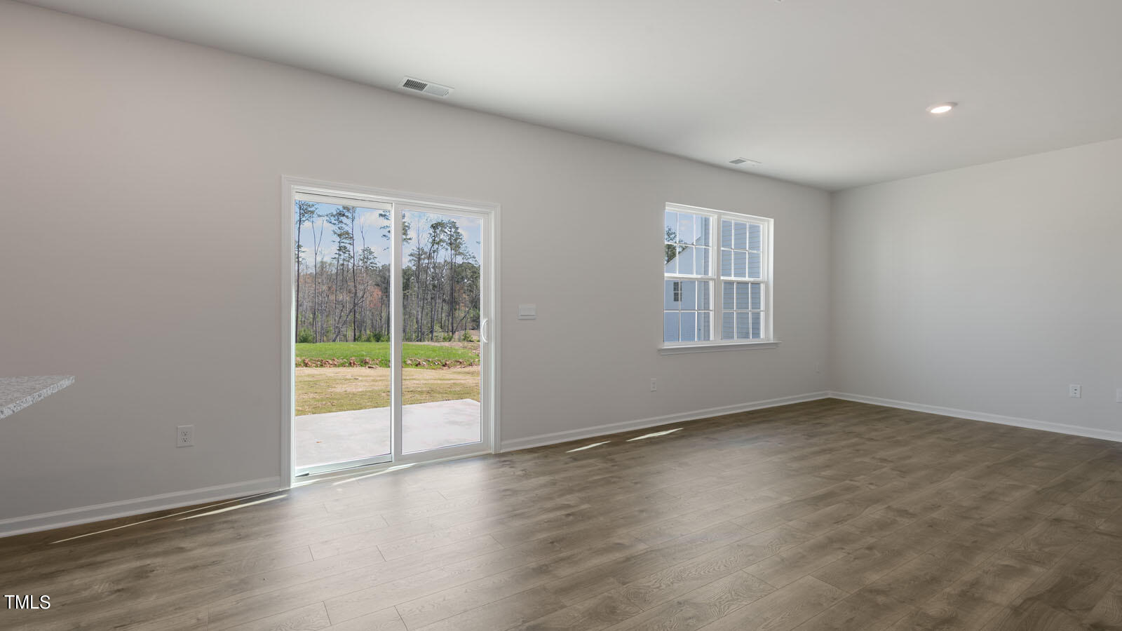 361 Ashley Run Sanford, NC 27330 - Photo 10 of 46 an empty room with wooden floor and windows