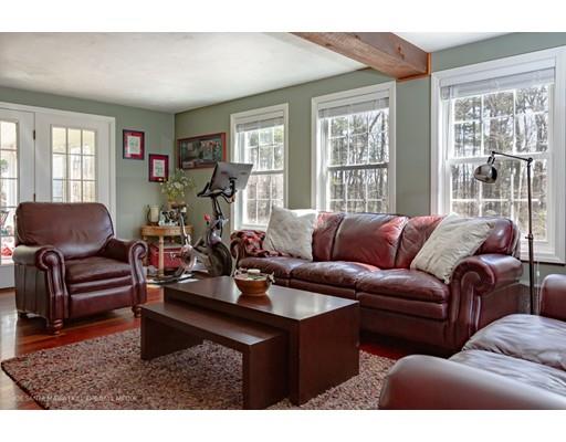 39 Champeaux Road Sturbridge, MA 01518 - Photo 8 of 25 a living room with furniture a wooden floor and a large window