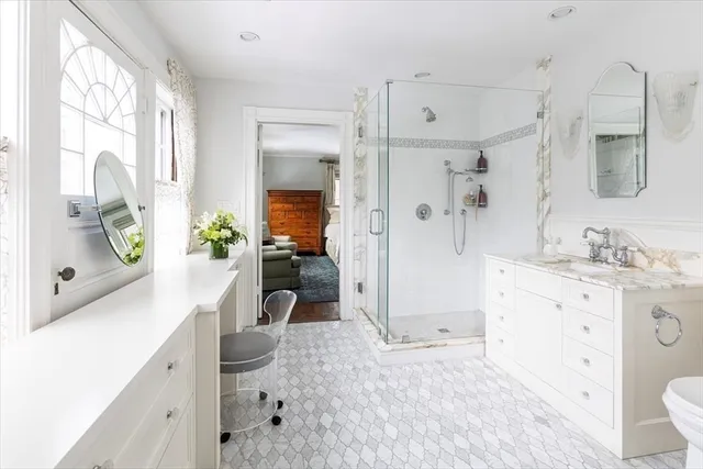 a spacious bathroom with a granite countertop sink mirror and shower
