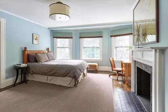 a bedroom with bed and a chandelier