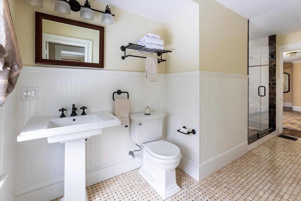 394 Hammond Street Newton, MA 02467 - Photo 15 of 24 a bathroom with a sink a toilet and shower