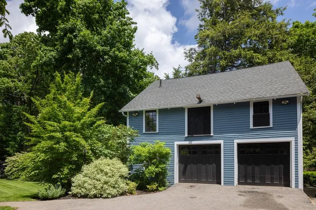 a front view of a house with yard and green space