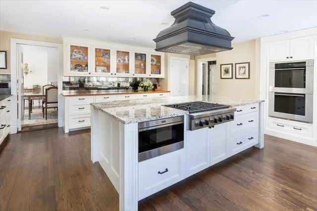 a kitchen with stainless steel appliances granite countertop a stove and a refrigerator