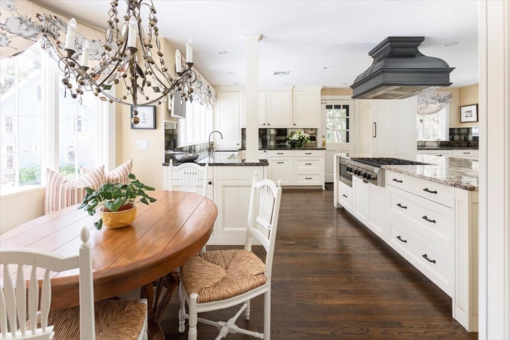 394 Hammond Street Newton, MA 02467 - Photo 8 of 24 a kitchen with stainless steel appliances kitchen island granite countertop a dining table chairs and white cabinets