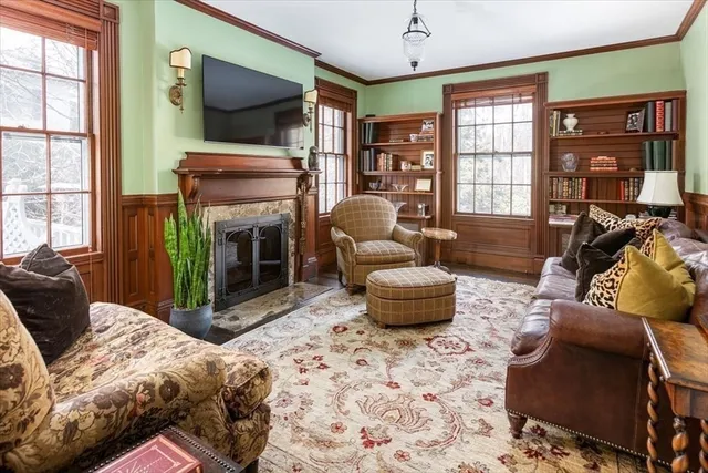 a living room with furniture a flat screen tv and a fireplace