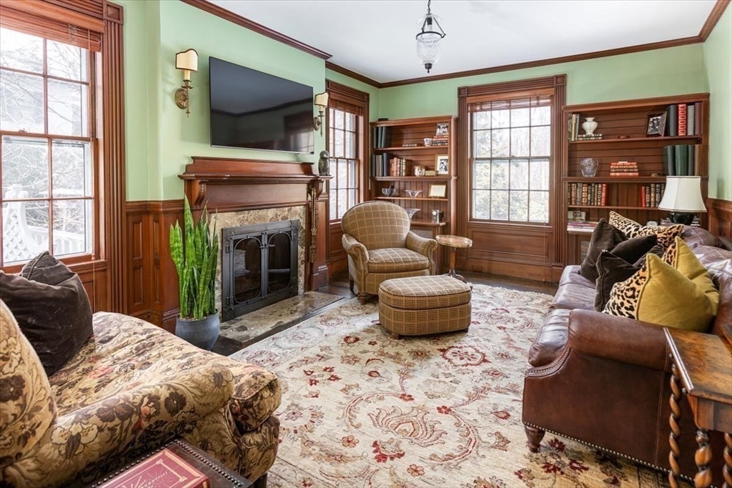 394 Hammond Street Newton, MA 02467 - Photo 9 of 24 a living room with furniture a flat screen tv and a fireplace