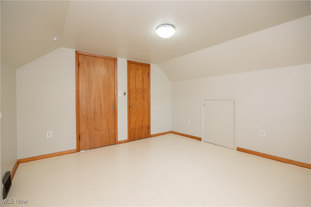 32575 Bagley Road North Ridgeville, OH 44039 - Photo 26 of 30 Additional living space with baseboards, concrete flooring, and lofted ceiling