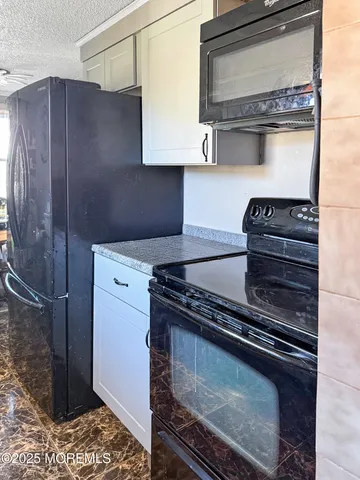 a stove top oven sitting inside of a kitchen